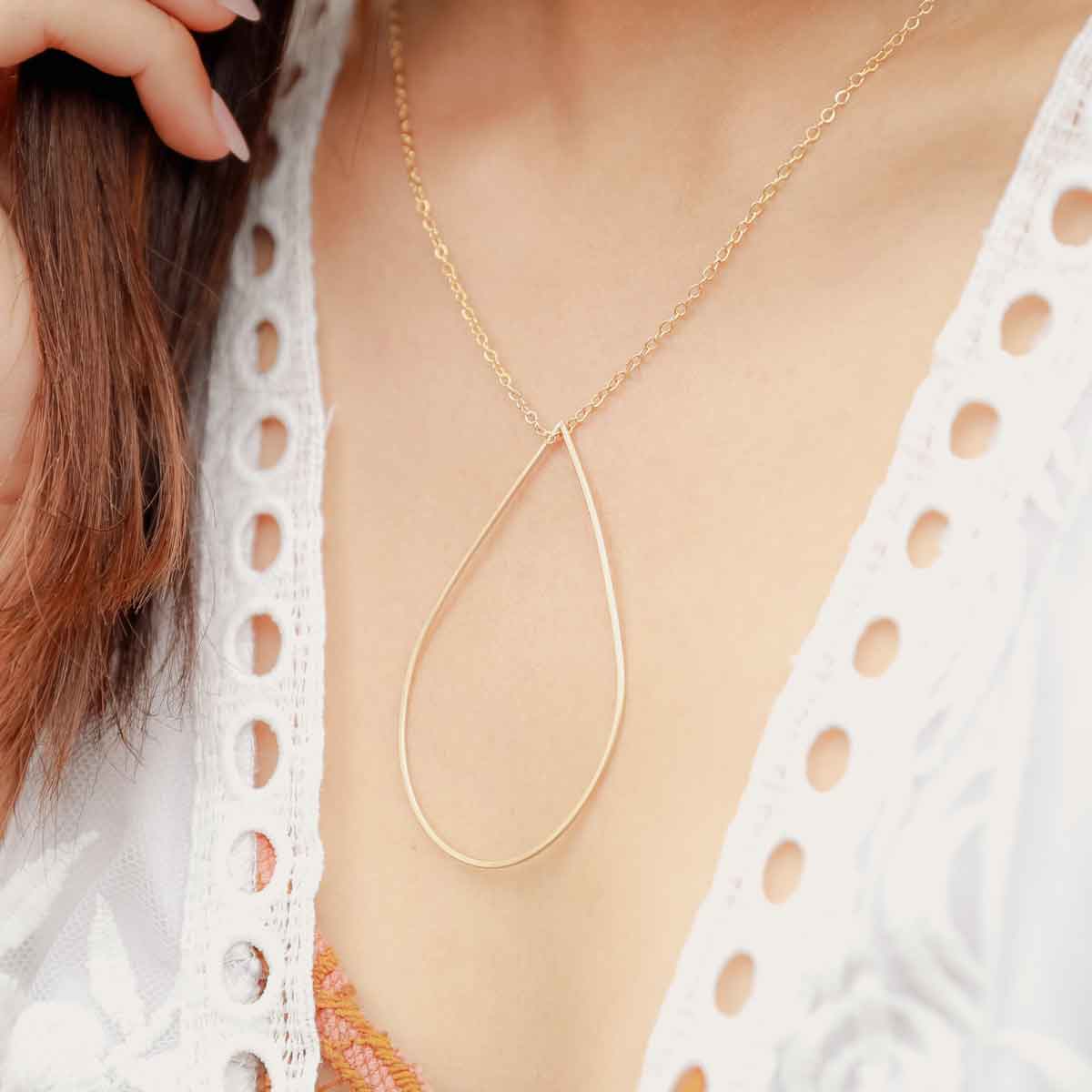 Girl wearing a gold filled Sorrow and Joy Teardrop Necklace