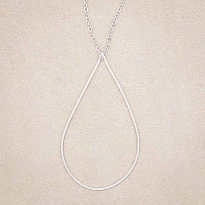 Sorrow and Joy Teardrop Necklace, handcrafted in sterling silver, on suede background
