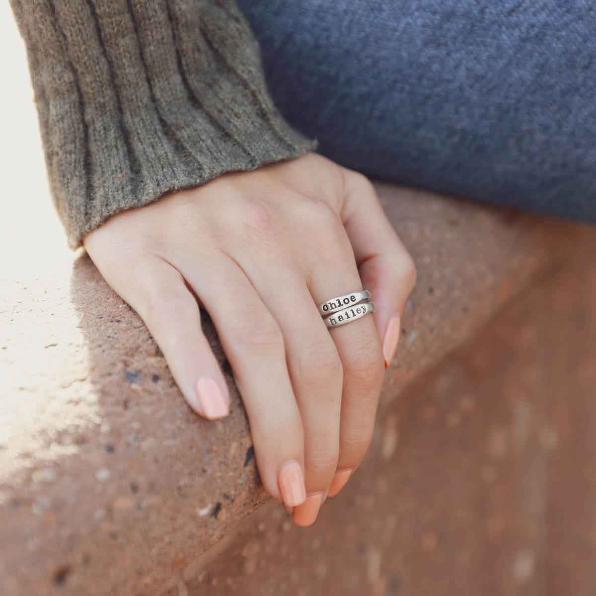 Woman wearing her Personalized sterling silver stackable name rings