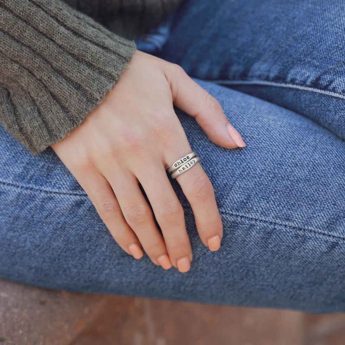 Woman wearing her sterling silver stackable name rings