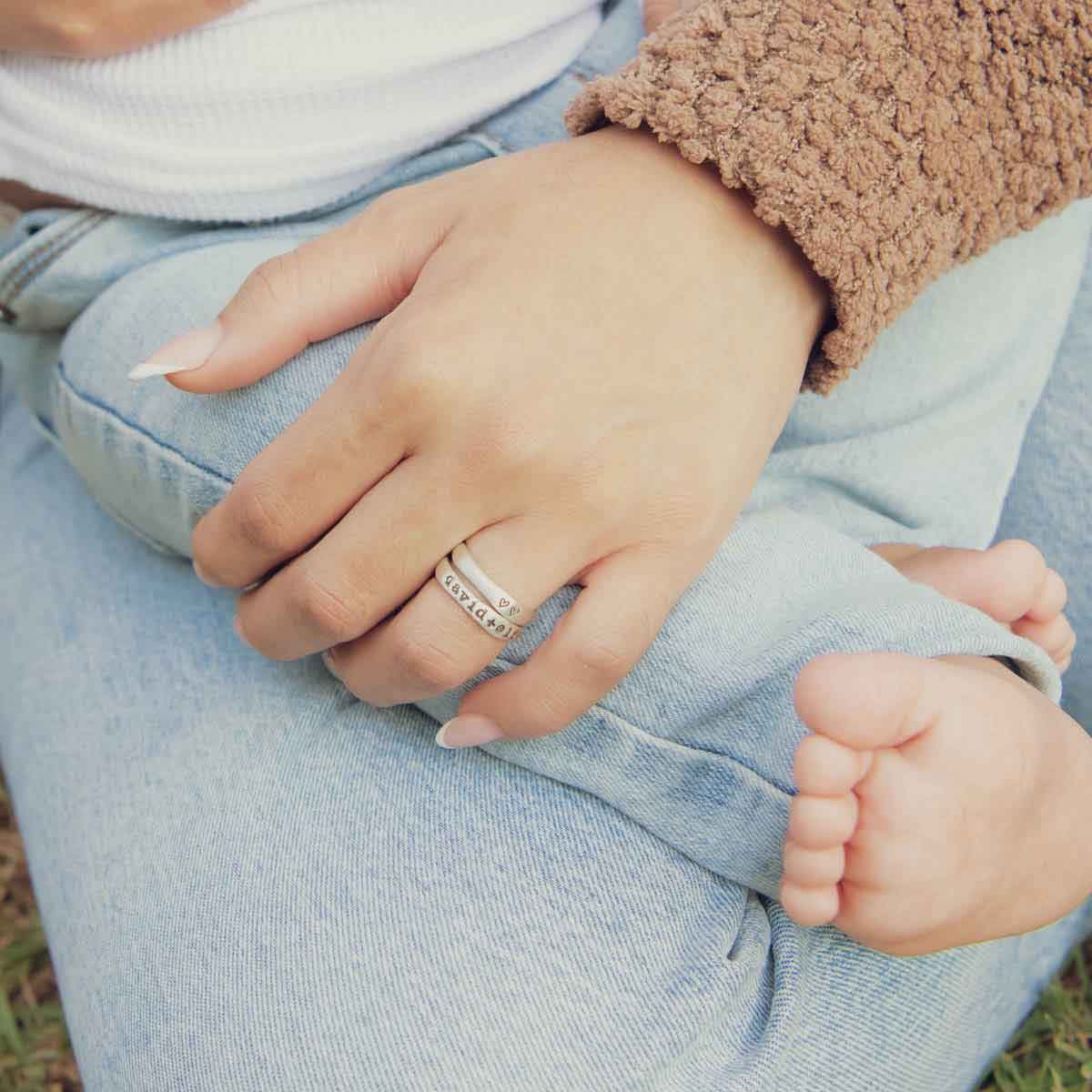 girl wearing sterling silver stackable name rings