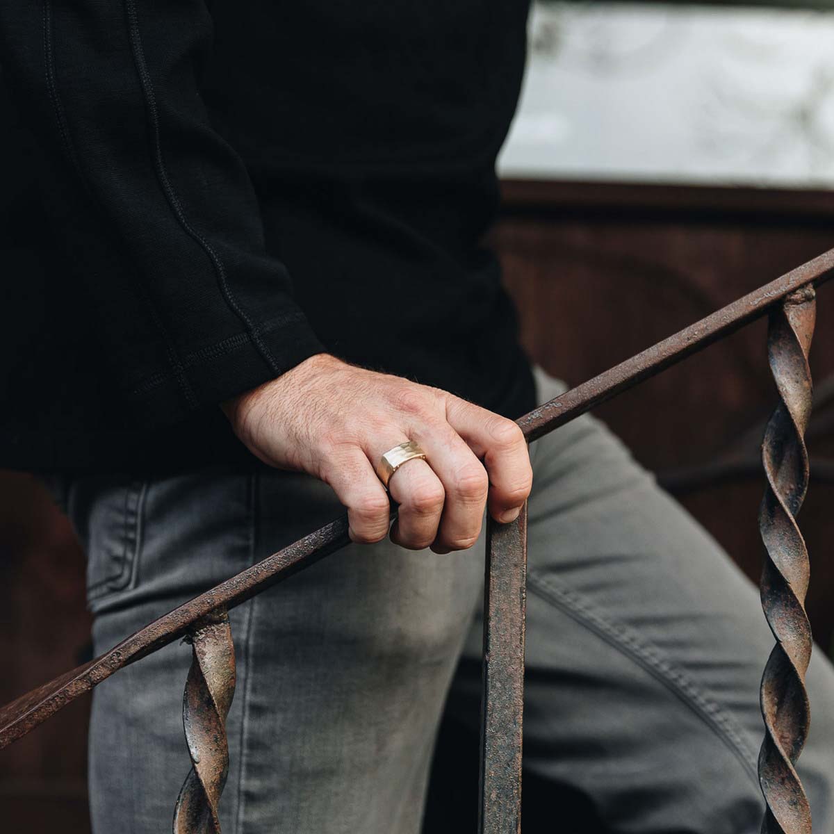 Man wearing Strong + True ring handcrafted in 14k yellow gold with a hammered finish and personalized with a meaningful name