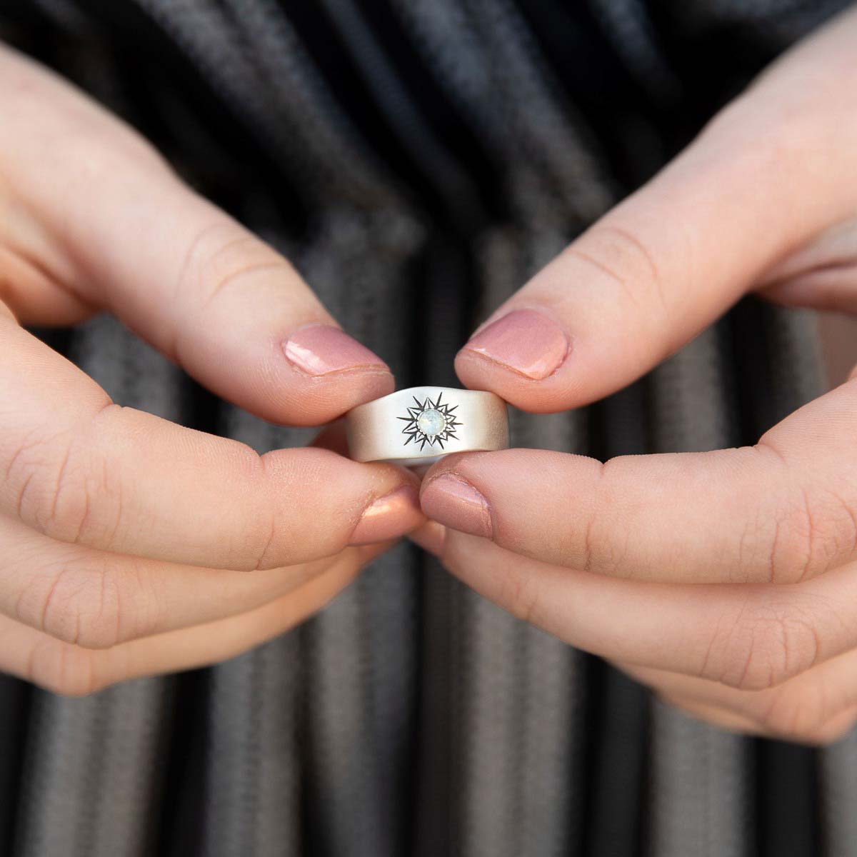 Girl wearing Sunburst birthstone ring handcrafted in sterling silver and set with a birthstone of your choice