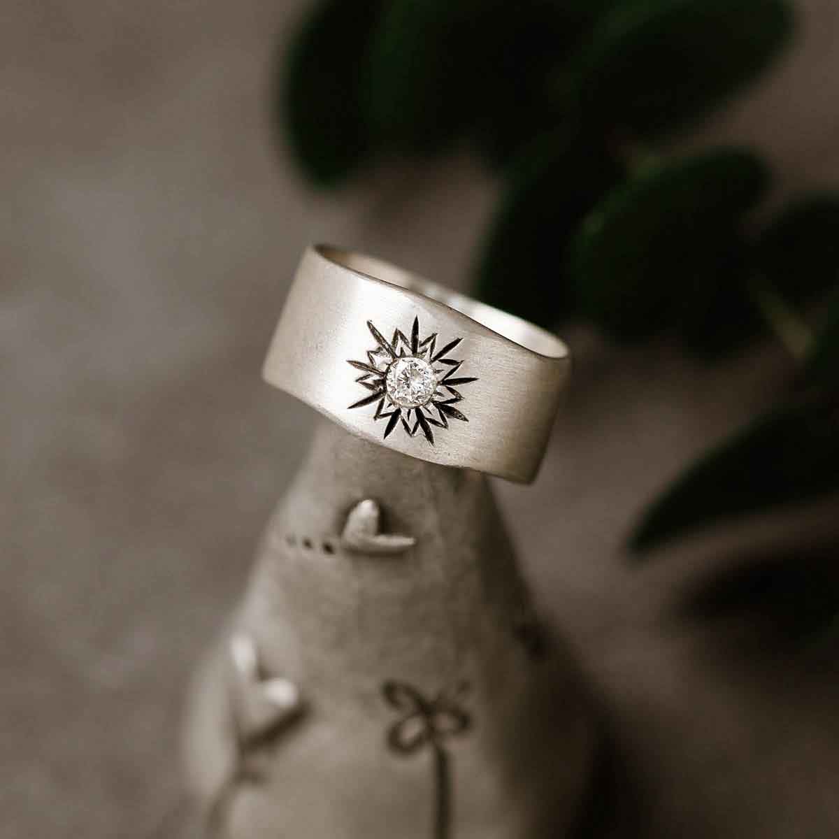 close up of sterling silver sunburst ring on woman's finger