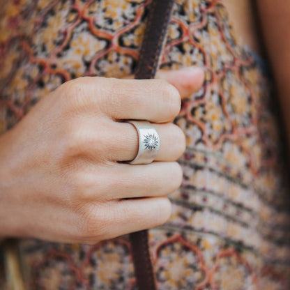 Girl wearing Sunburst crystal ring handcrafted in sterling silver and set with a 3mm bright cubic zirconia stone