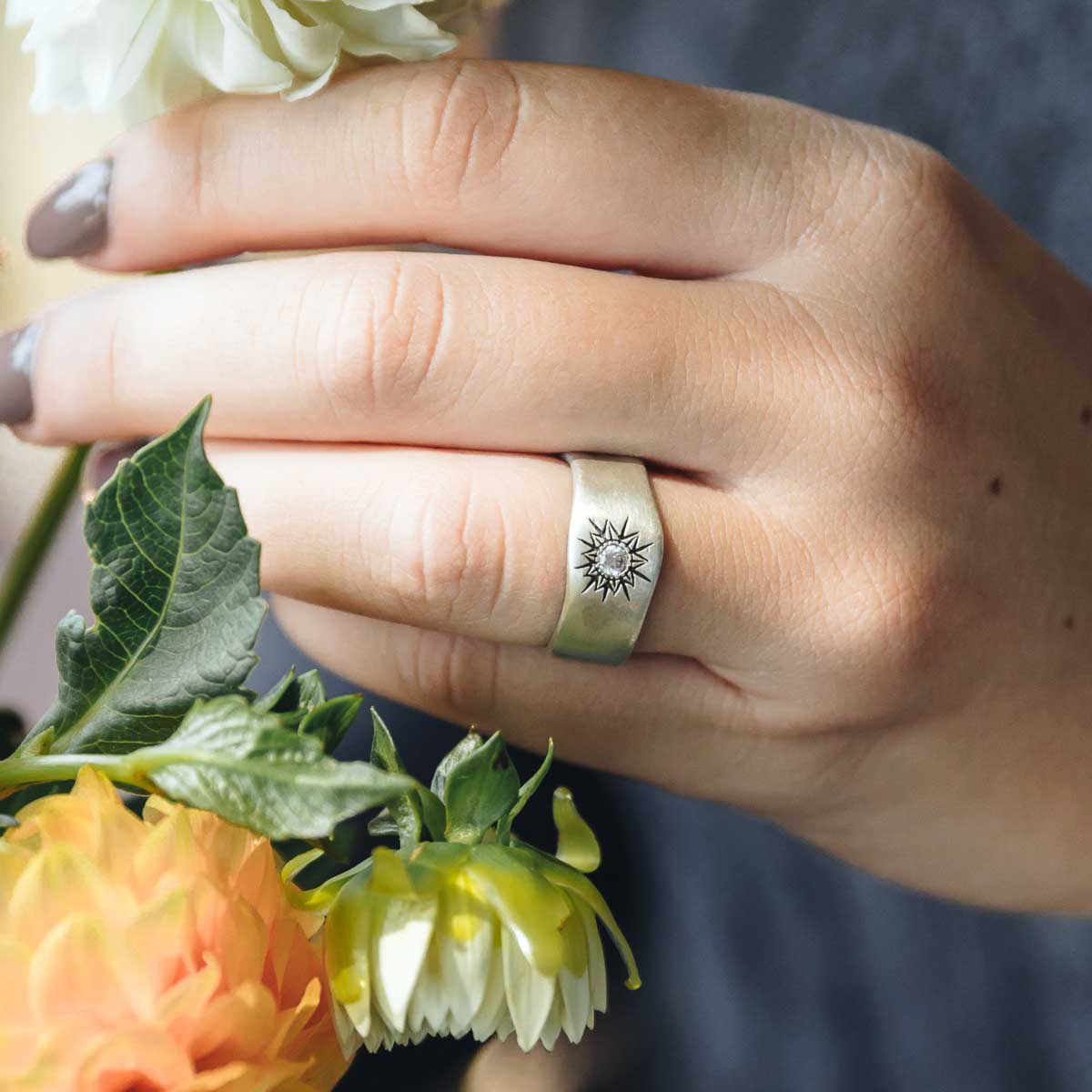 Girl wearing Sunburst crystal ring handcrafted in sterling silver and set with a 3mm bright cubic zirconia stone