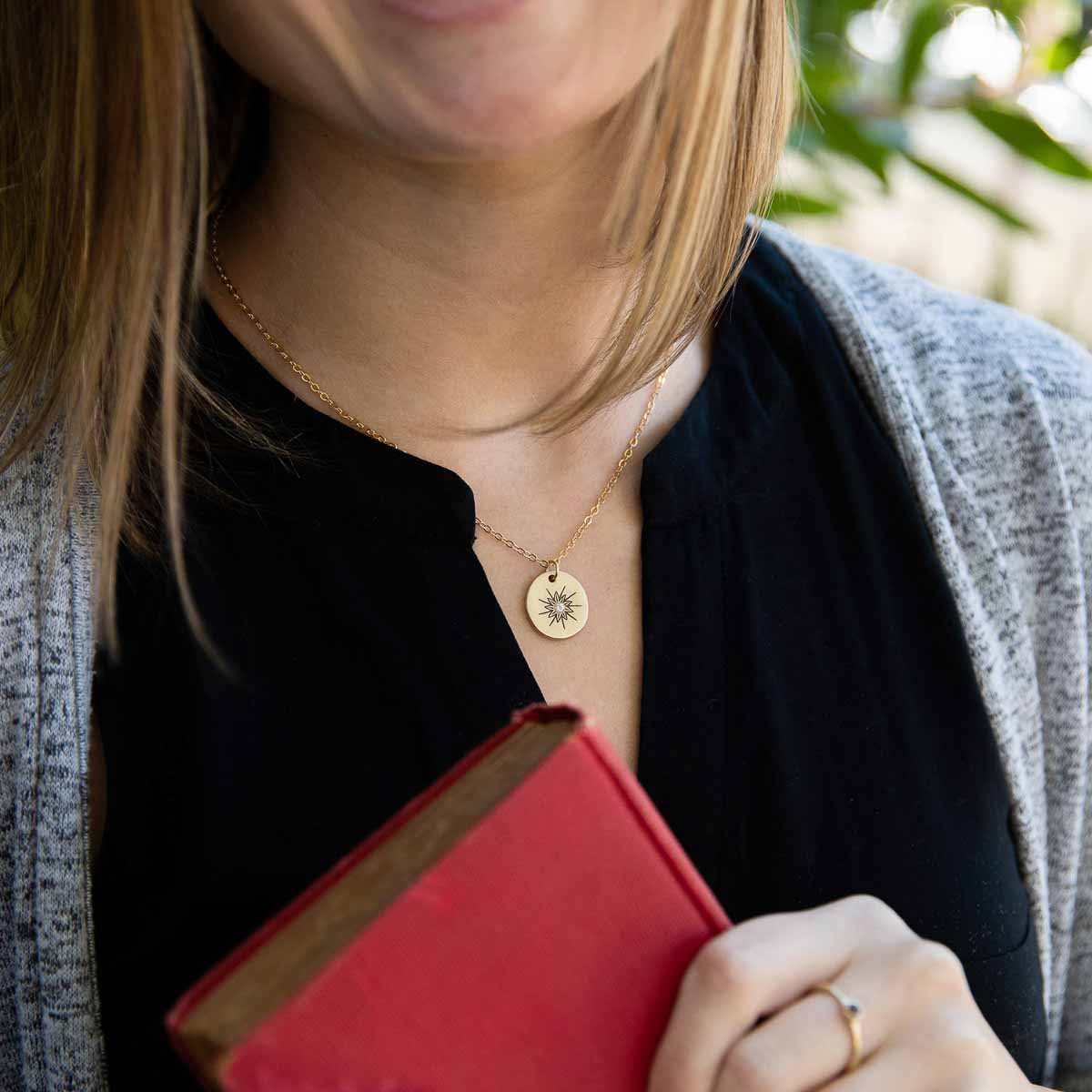 girl wearing 10k yellow gold sunburst diamond necklace 