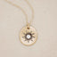 14k yellow gold sunburst diamond necklace on beige background