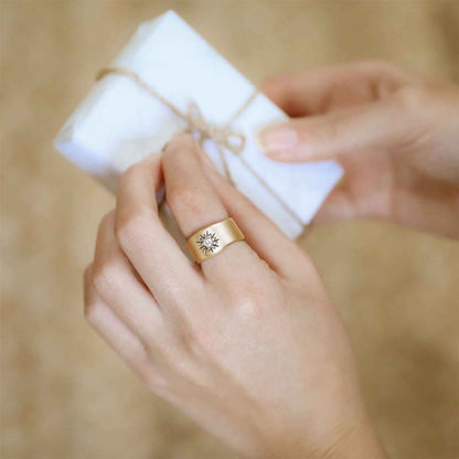 girl holding her 10k yellow gold sunburst diamond ring with a 3mm conflict free diamond in a lisa leonard ring box