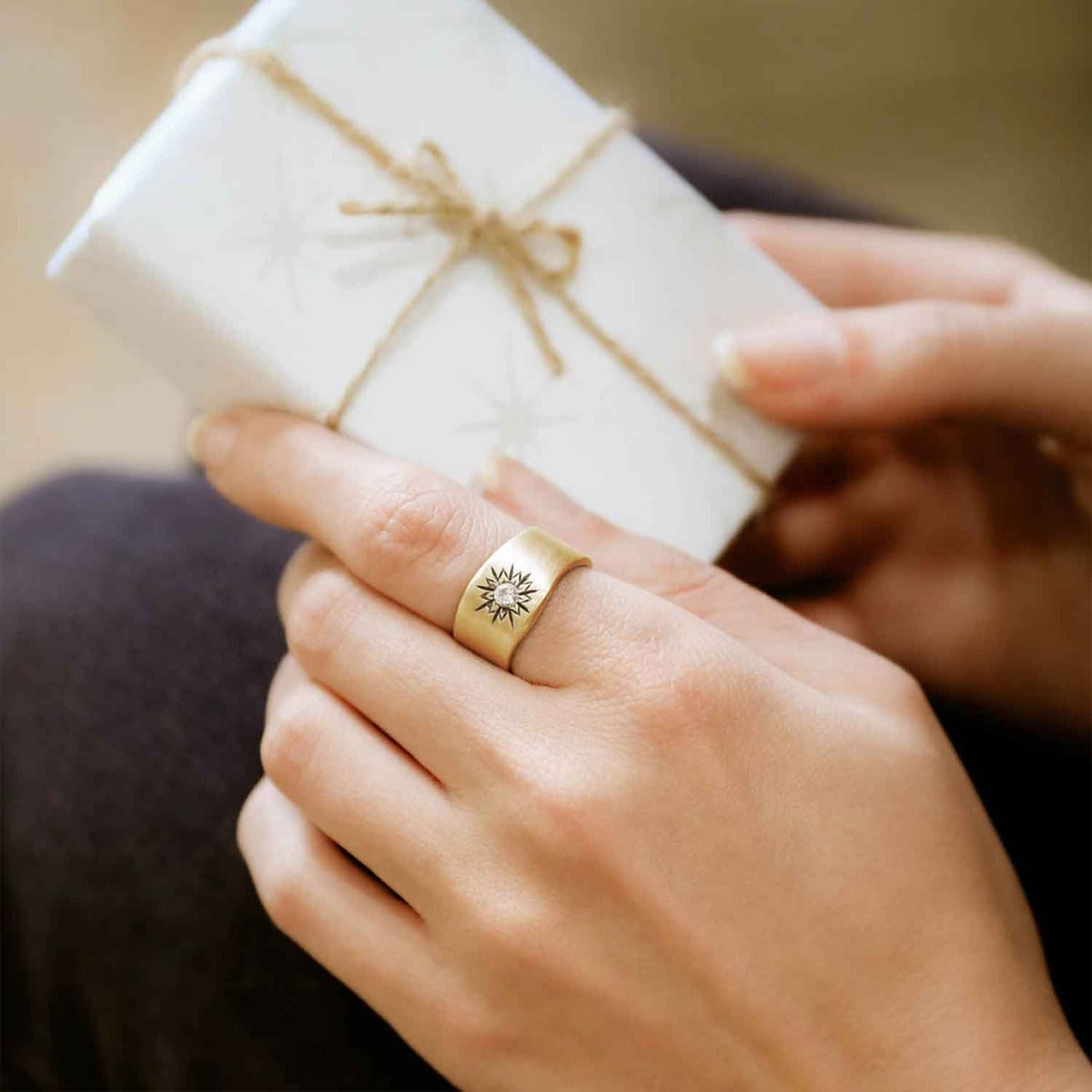 Girl wearing Sunburst birthstone ring handcrafted in 10k yellow gold and set with a birthstone of your choice