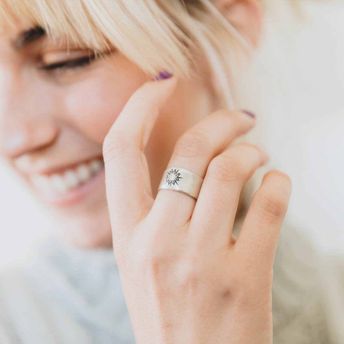 Girl wearing her 10k white gold sunburst diamond ring with a 3mm conflict free diamond