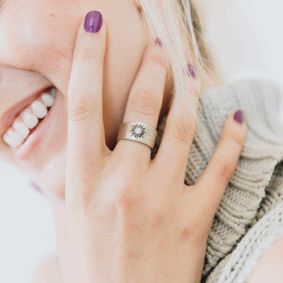 Girl wearing her 10k white gold sunburst diamond ring with a 3mm conflict free diamond