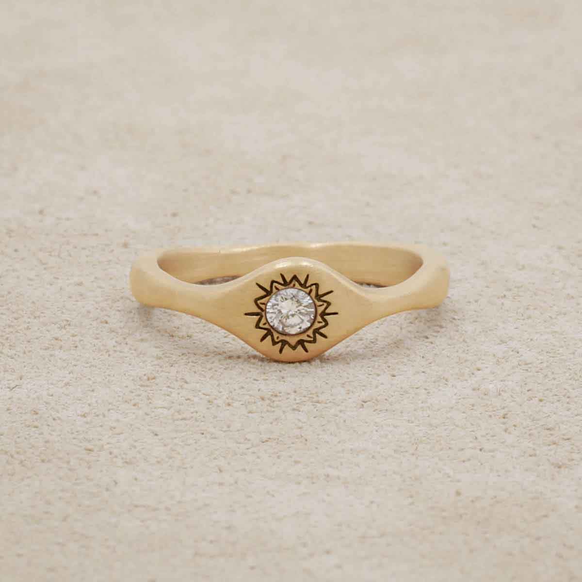 Sunburst stacking ring handcrafted in 14k yellow gold and set with a 3mm bright genuine diamond