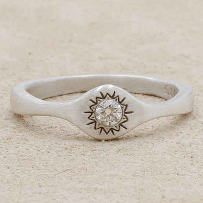 Girl wearing Sunburst stacking ring handcrafted in sterling silver and set with a 3mm bright genuine diamond with other sterling silver jewelry