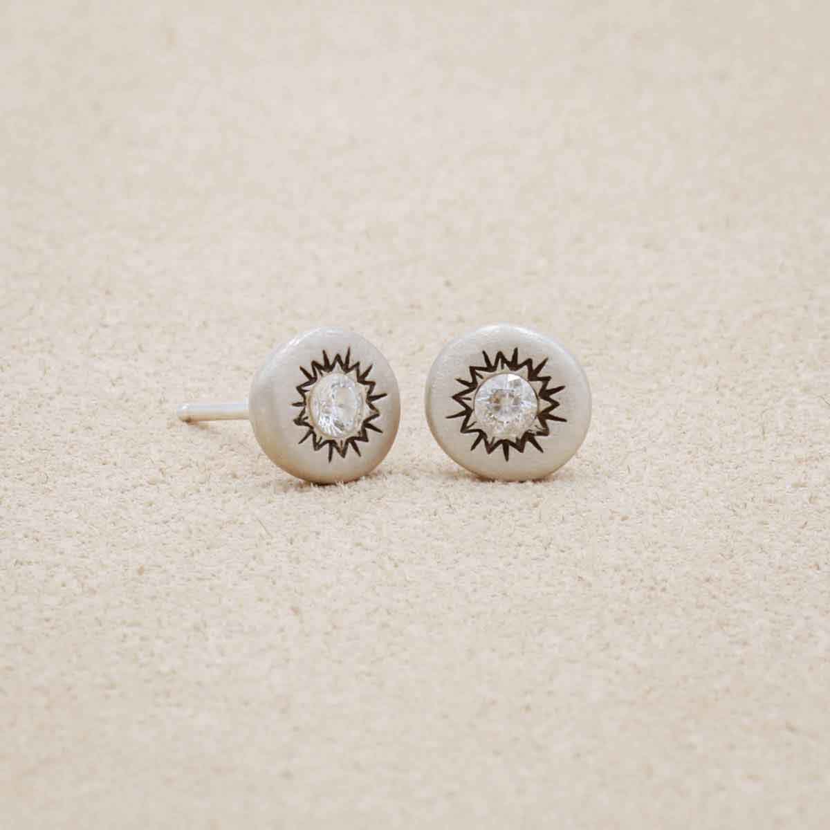 pair of sterling silver sunburst stud earrings with a matte-brushed finish with 3mm crystals