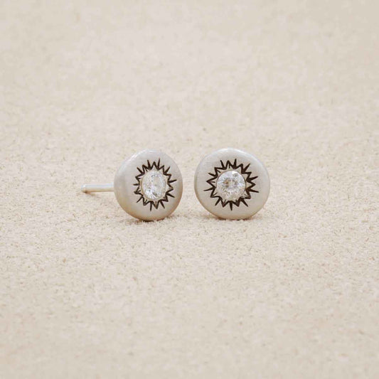 pair of sterling silver sunburst stud earrings with a matte-brushed finish with 3mm crystals