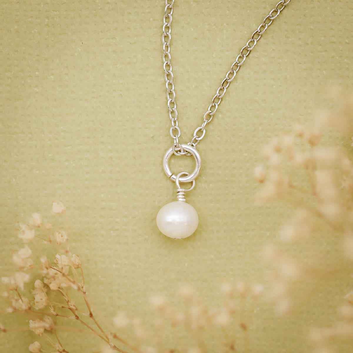 Sweet Dainty Freshwater Pearl Necklace on green texture with flowers