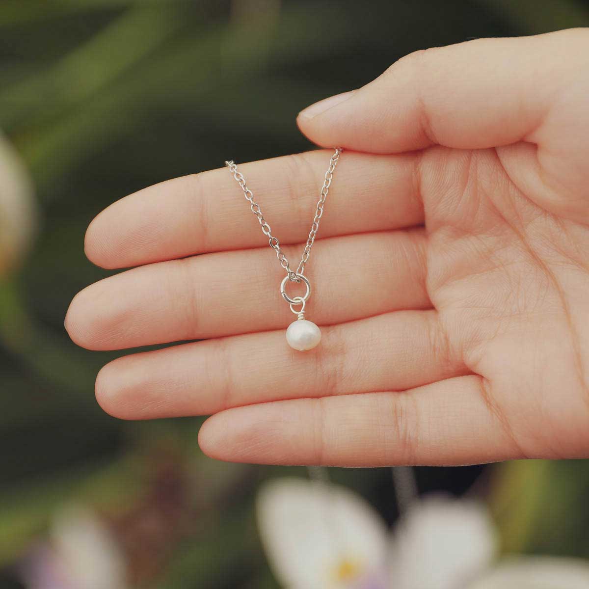 Hand holding a Sweet Dainty Freshwater Pearl Necklace