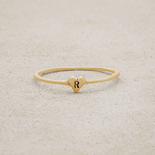 10k yellow gold Sweet Love Initial Ring - One Heart on beige background