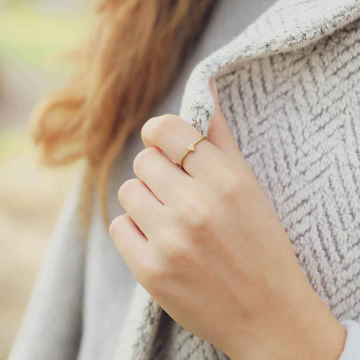 girl wearing a 14k yellow gold sweet love ring - one heart