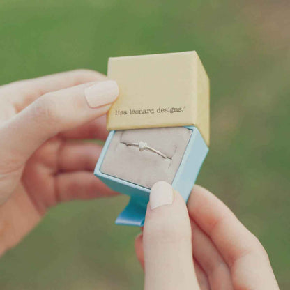 girl holding a sterling silver sweet love ring - one heart  in a lisa leonard ring box