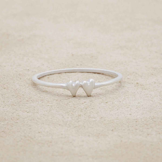 sterling silver sweet love ring with two hearts on a suede background