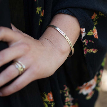 Woman wearing her personalized thin gold cuff 10k gold