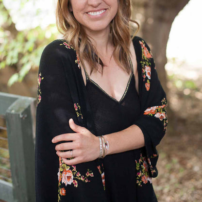 Girl wearing sterling silver and gold jewelry including  a thin gold cuff