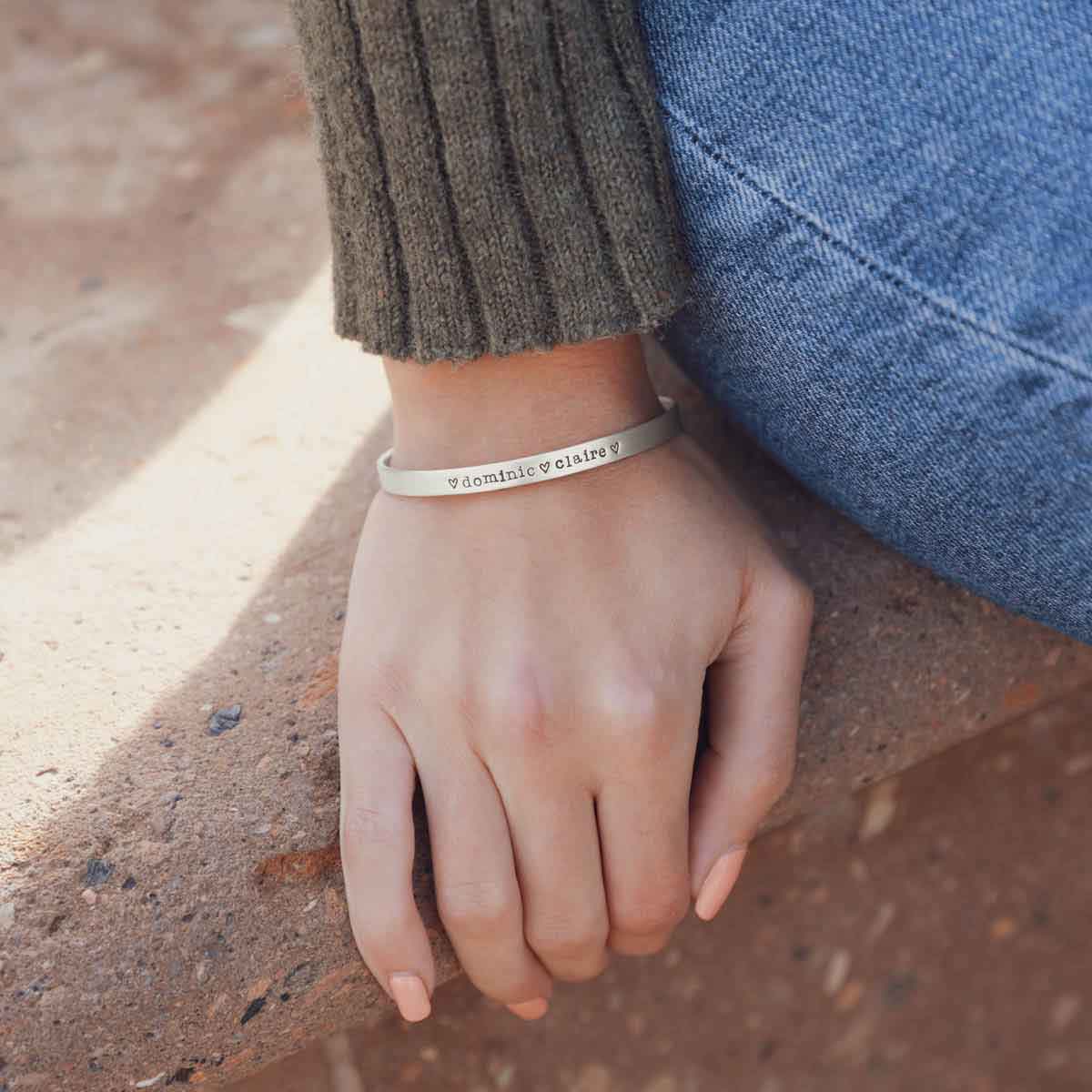 Girl wearing her personalized sterling silver jewelry including her thin sterling cuff