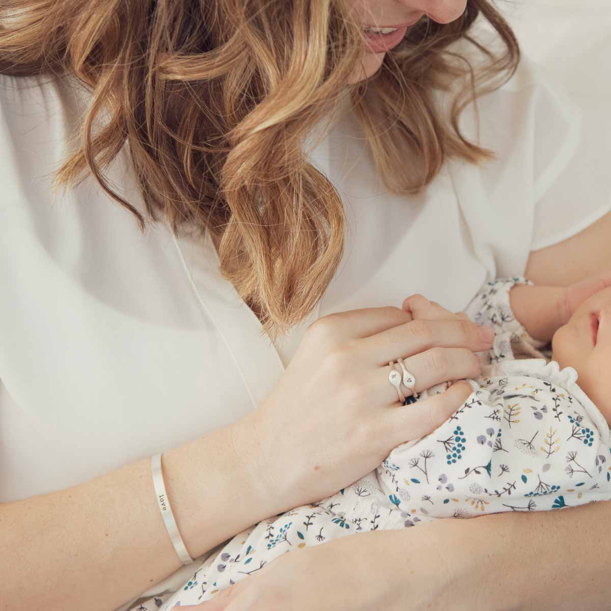 Woman with her child while wearing a sterling silver thin cuff bracelet