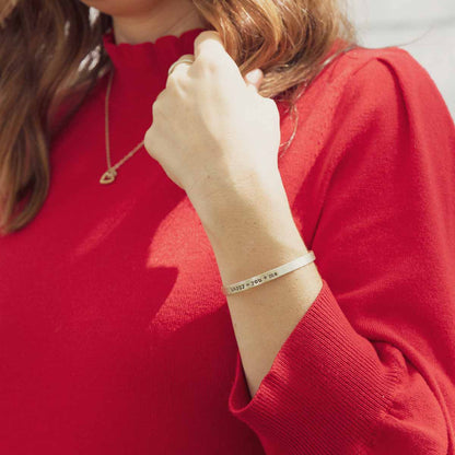 woman wearing a personalized Thin Sterling Cuff cast in Sterling Silver with a freshwater pearl