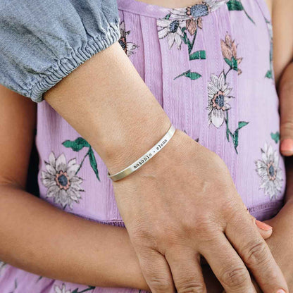 Woman with her daughter while wearing a sterling silver thin cuff bracelet