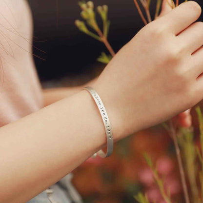 Girl showing her personalized sterling silver jewelry including her thin sterling cuff