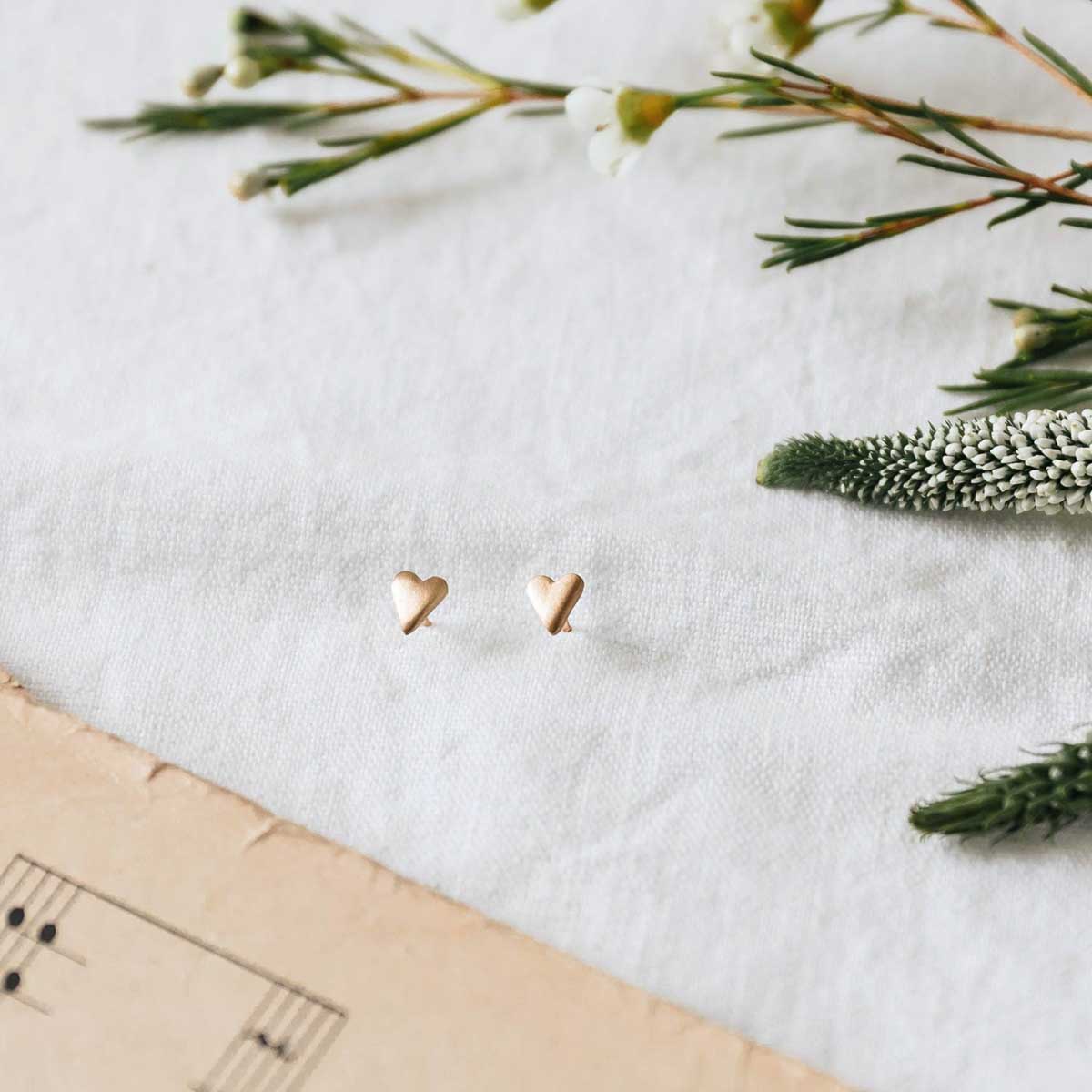 10k yellow gold tiny heart stud earrings with a matte brushed finish