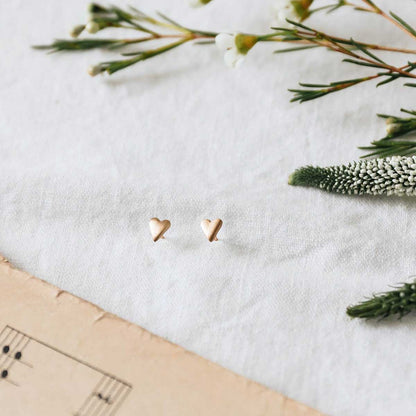 10k yellow gold tiny heart stud earrings with a matte brushed finish