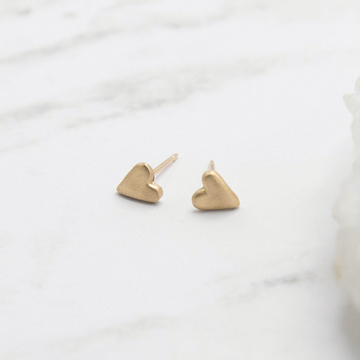 10k yellow gold tiny heart stud earrings with a matte brushed finish