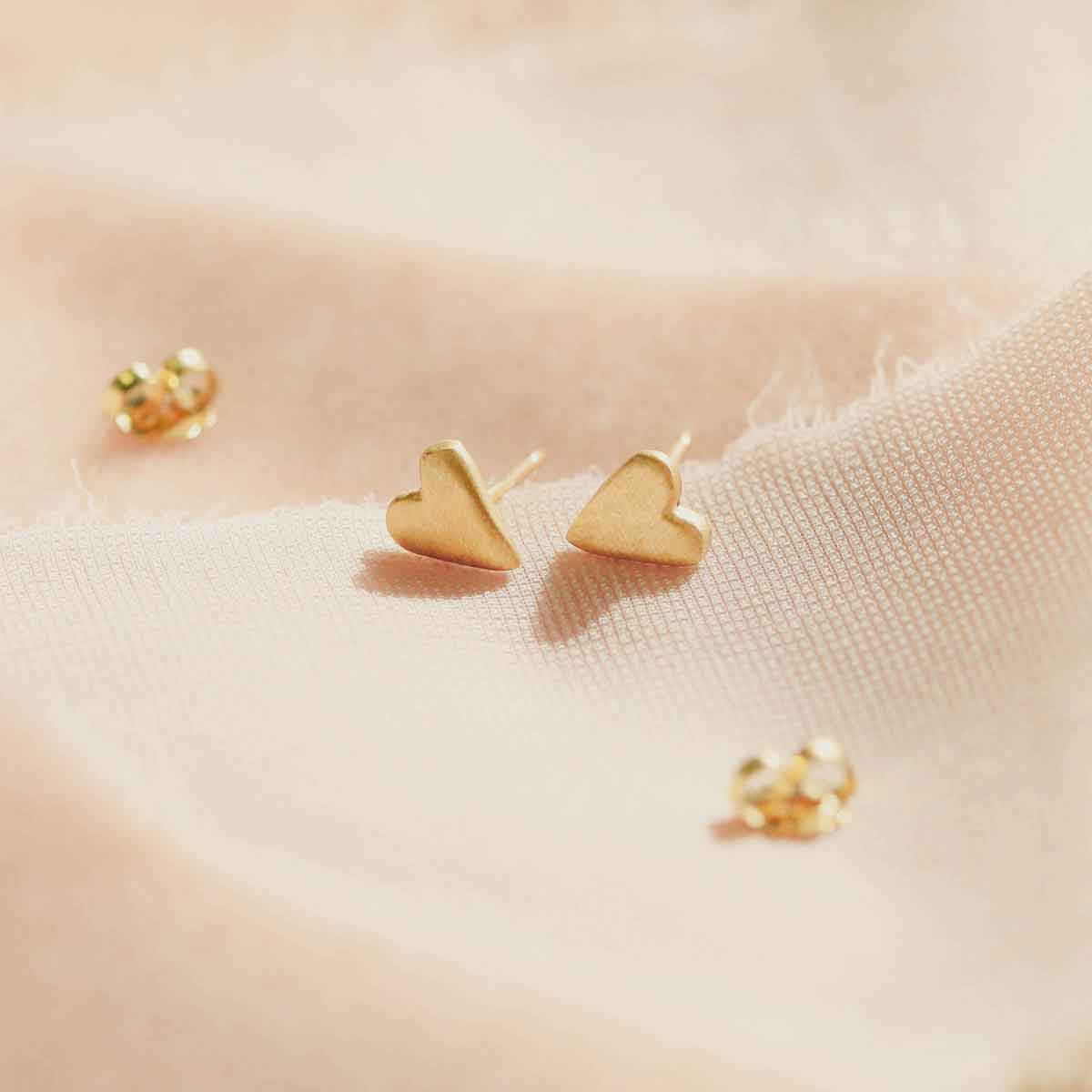 14k yellow gold tiny heart stud earrings with a matte brushed finish