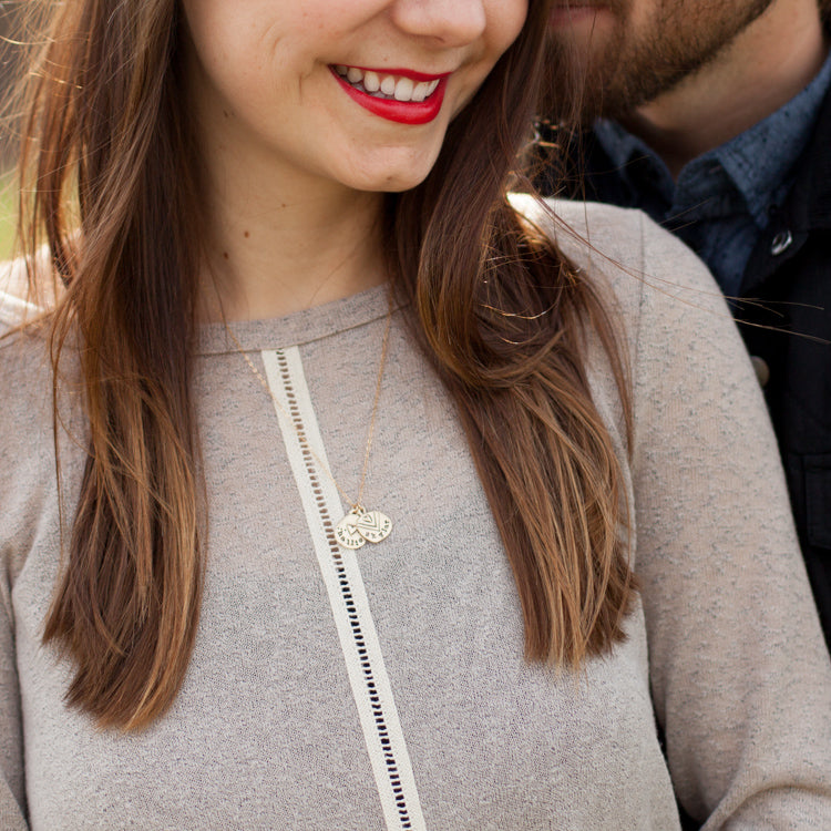 woman wearing her handcrafted 10k yellow gold personalized jumble of love necklace with her partner