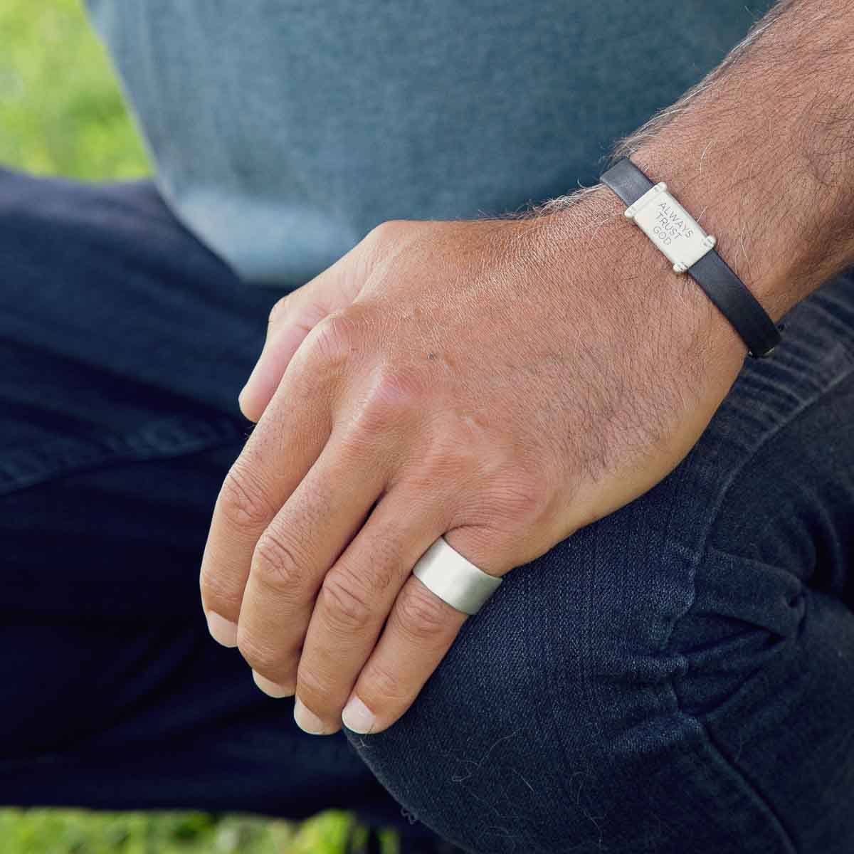 Man wearing Valor Wide ring handcrafted in sterling silver customizable with a meaningful name