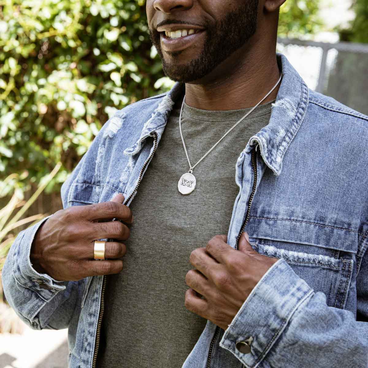 Man wearing Valor Wide ring handcrafted in sterling silver customizable with a meaningful name