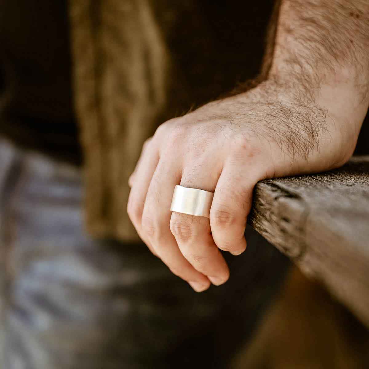 Man wearing Valor Wide ring handcrafted in sterling silver customizable with a meaningful name