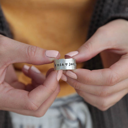 Girl wearing her Very fine line ring handcrafted in sterling silver with a satin/antiqued finish customizable with a name