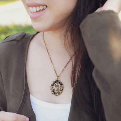 girl wearing a gold plated vintage cameo necklace engraved with flowers 