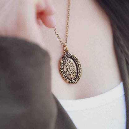 girl wearing a gold plated vintage cameo necklace engraved with flowers 