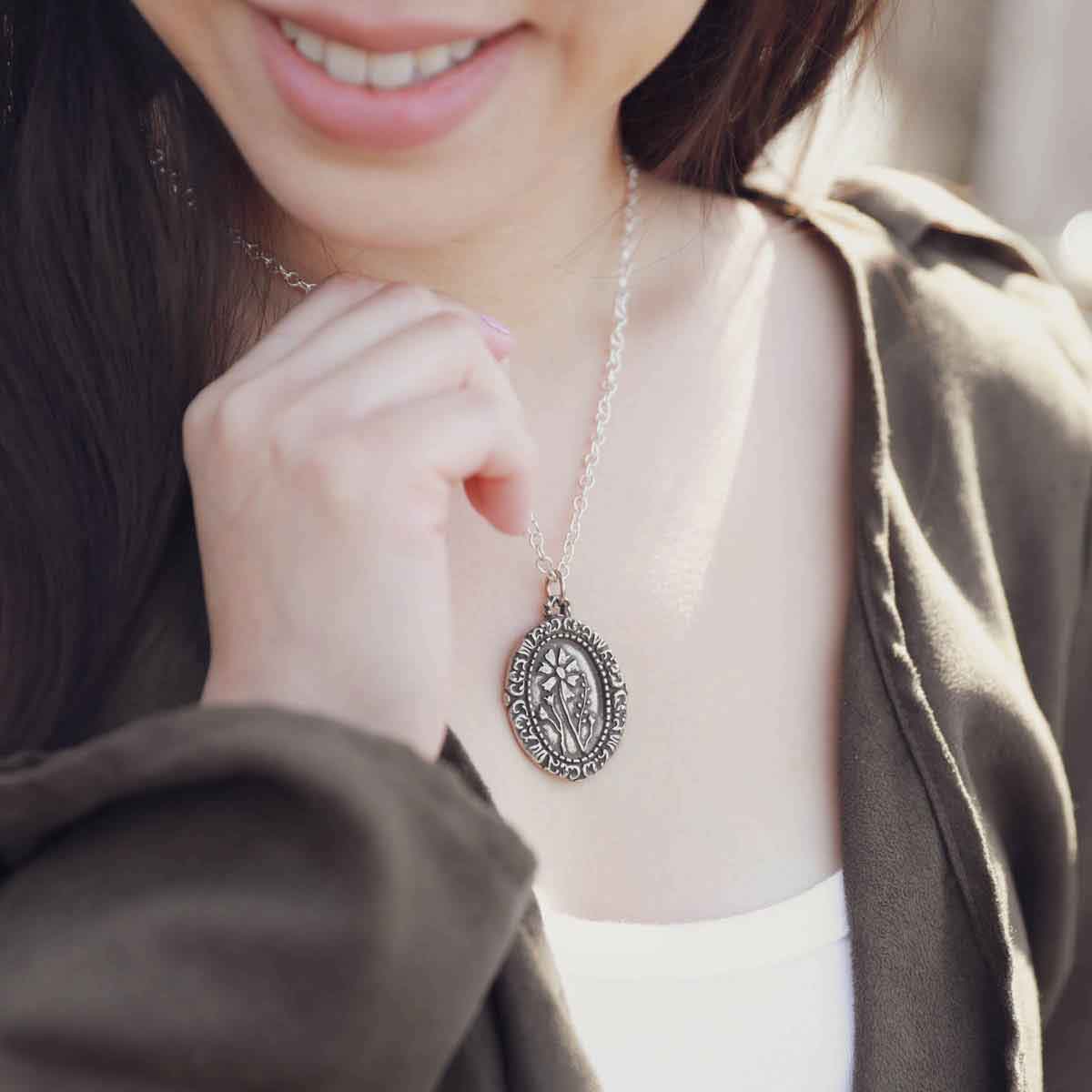 girl wearing a pewter vintage cameo necklace