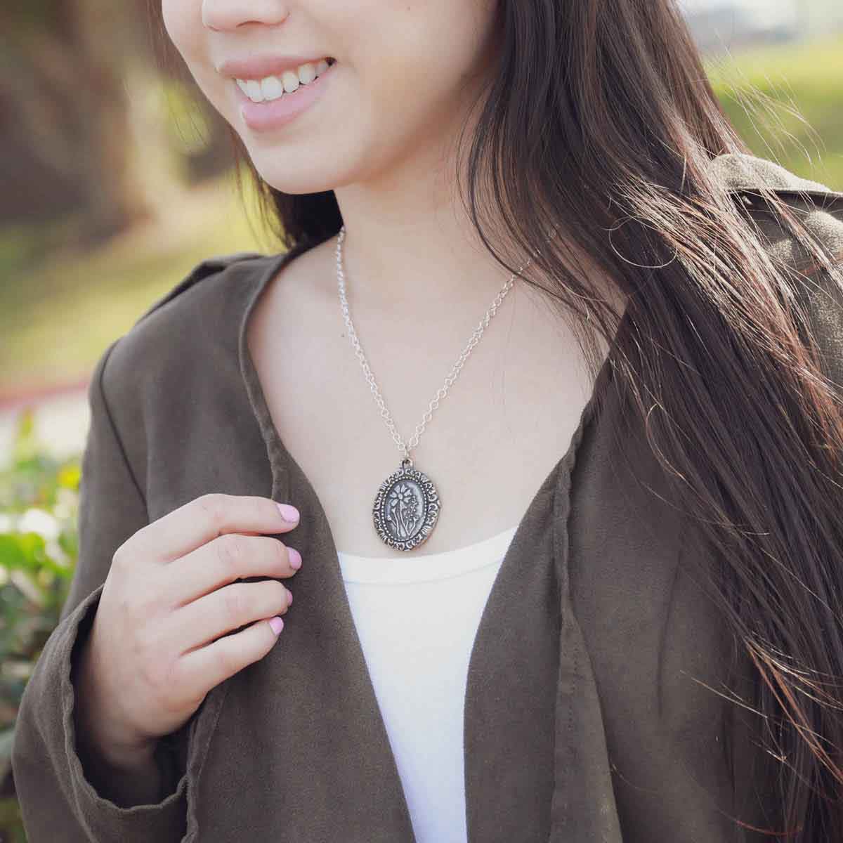 girl wearing a pewter vintage cameo necklace