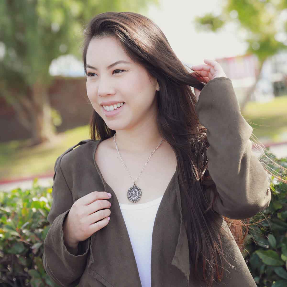 girl wearing a pewter vintage cameo necklace