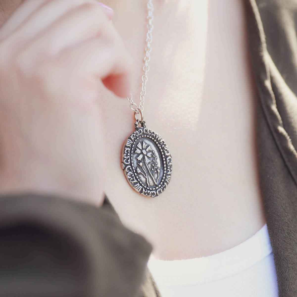 girl wearing a pewter vintage cameo necklace