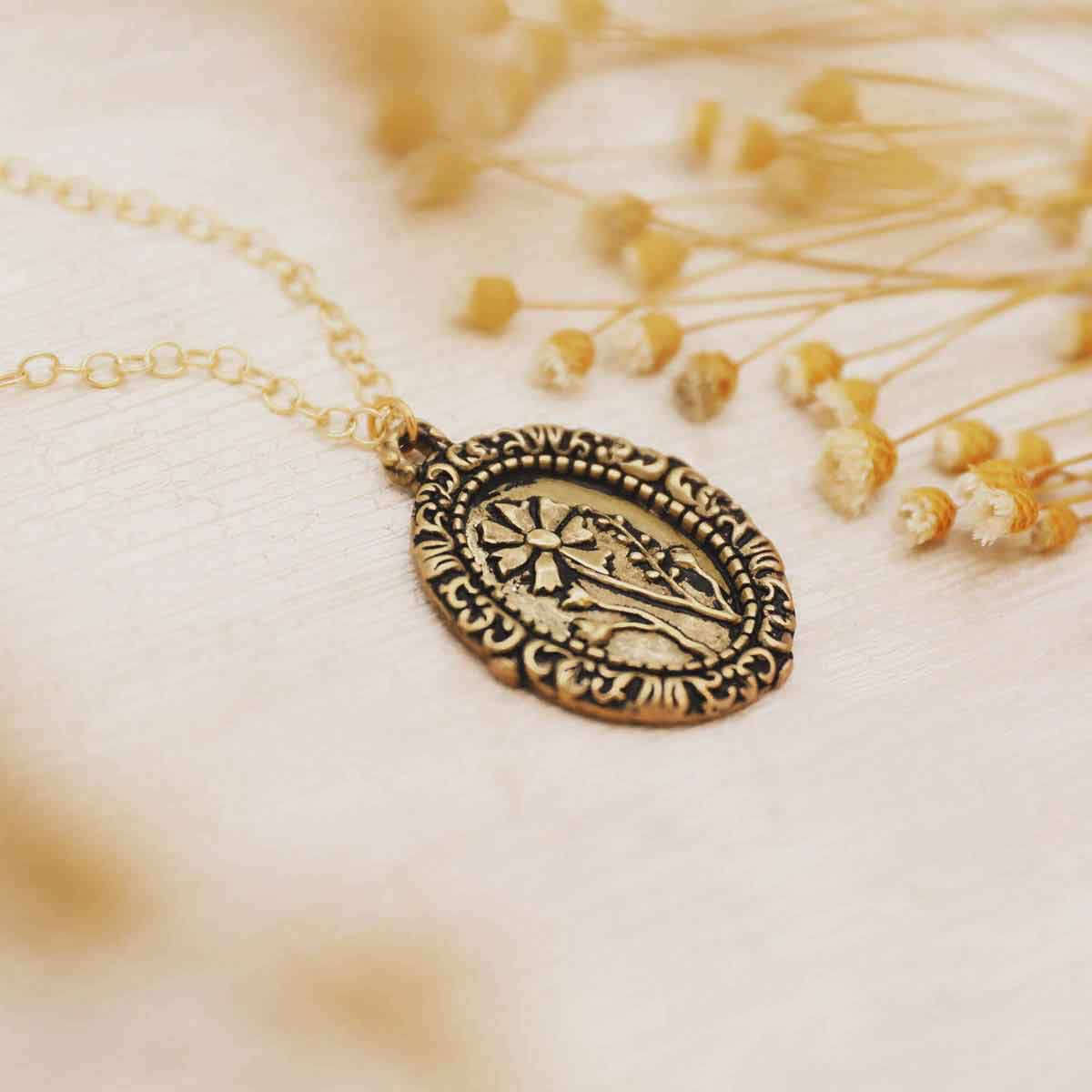 gold plated vintage cameo necklace with floral background