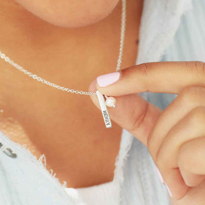 girl holding word of the year necklace